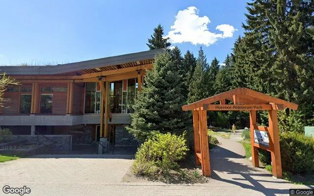 Whistler Public Library, a timber building on Main Street beside the Florence Petersen Park sign